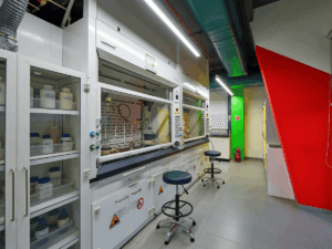Lab furniture at a specialty chemical company in Juinagar, Navi Mumbai, featuring storage cabinets and a fume hood for safe and organized chemical handling.