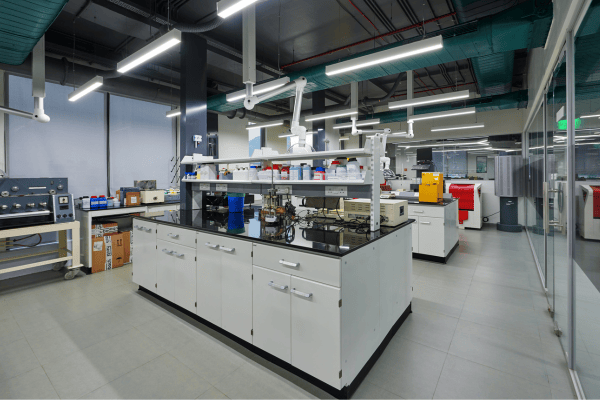 Lab workstations at a specialty chemical company in Juinagar, featuring pegboards for glassware drying and spot extractors for localized fume extraction.